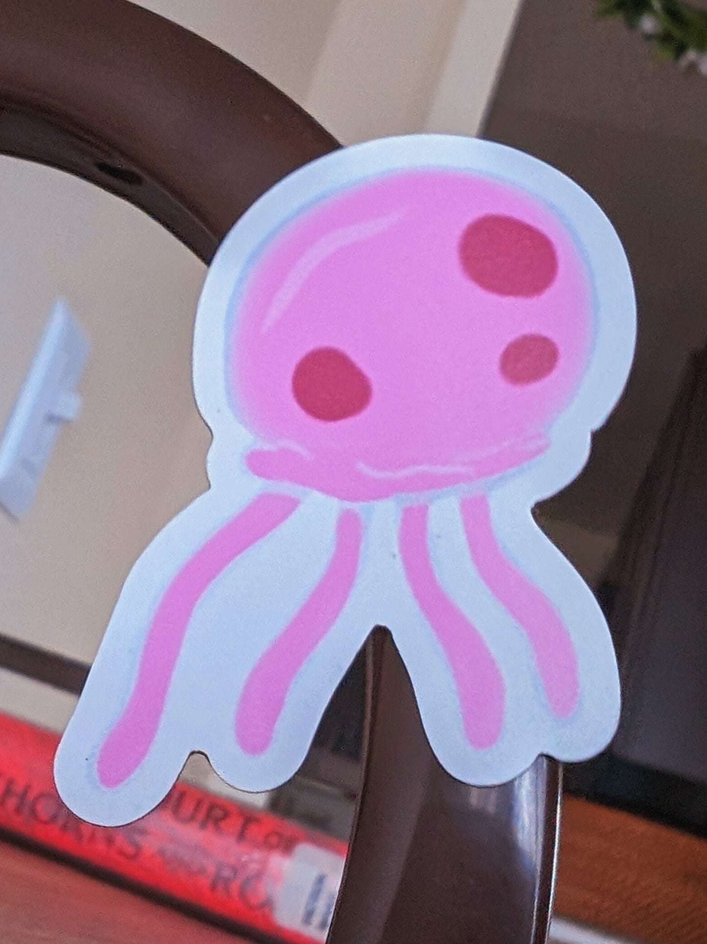 pink jellyfish magnet, digitally drawn, on a metal dresser frame