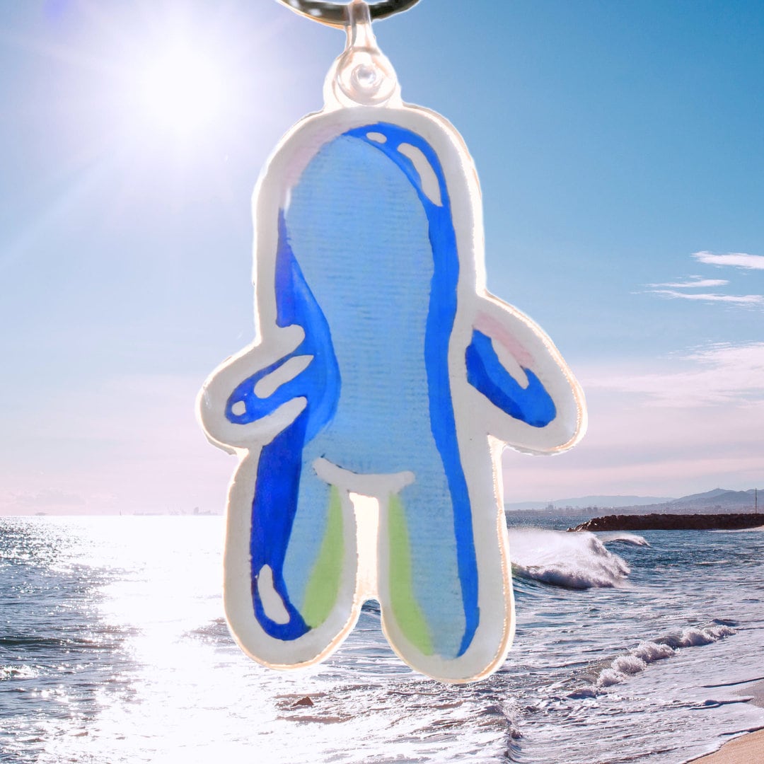 sky blue bubble bud keychain hanging out on the beach on a sunny day